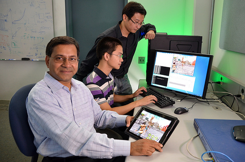 man smiling with tablet in hand